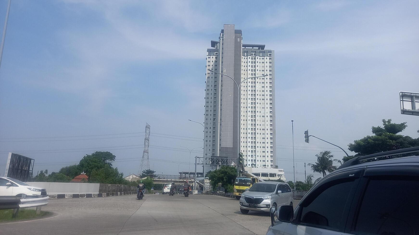 a tall building with a car driving by photo