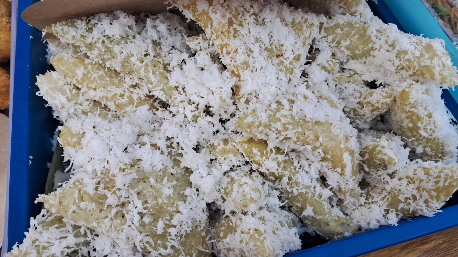 Traditional food made from sticky rice topped with grated coconut photo