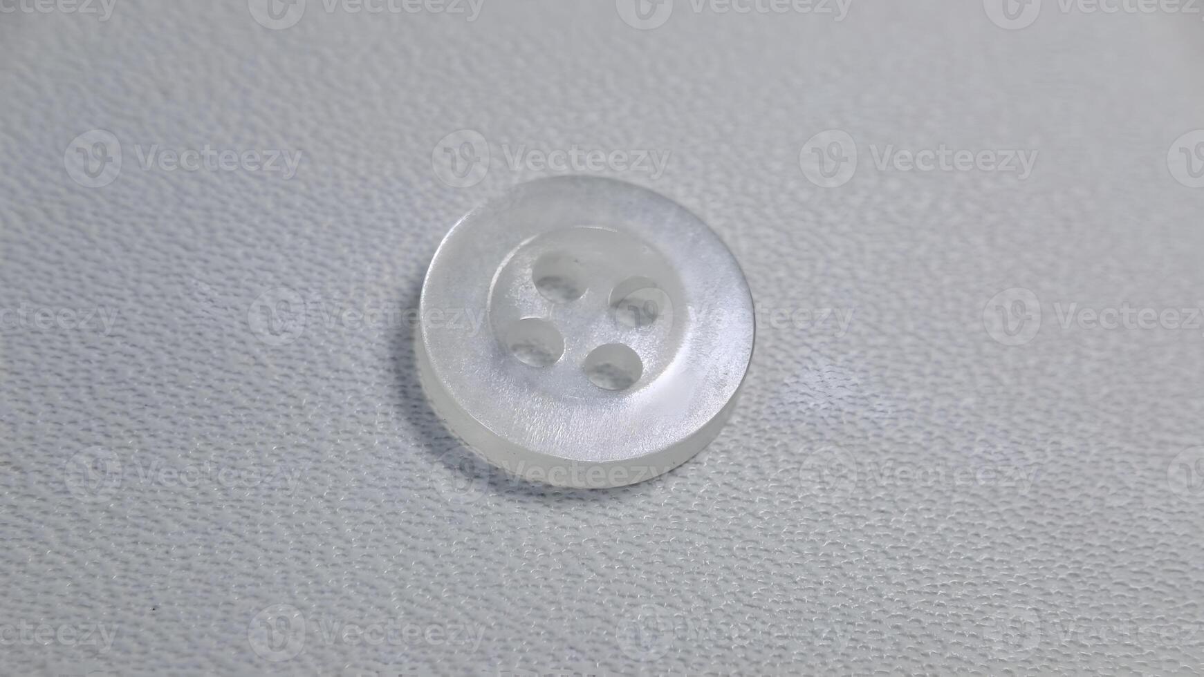 transparent shirt buttons isolated on white photo