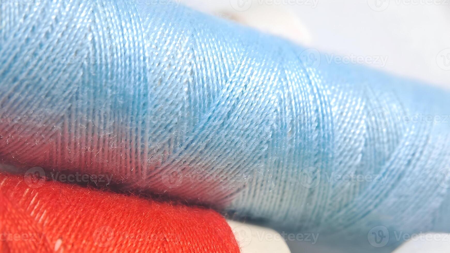 a spool of thread with blue and red colors photo