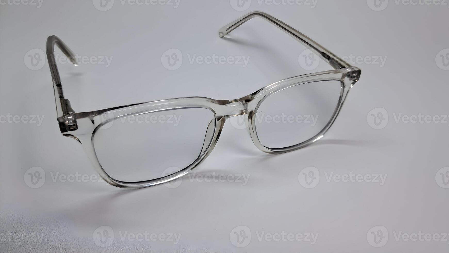 a pair of glasses with clear lenses on a white surface photo