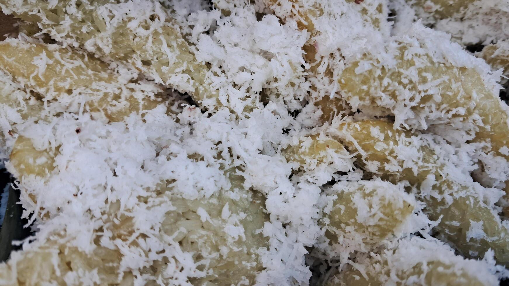 Traditional food made from sticky rice topped with grated coconut photo