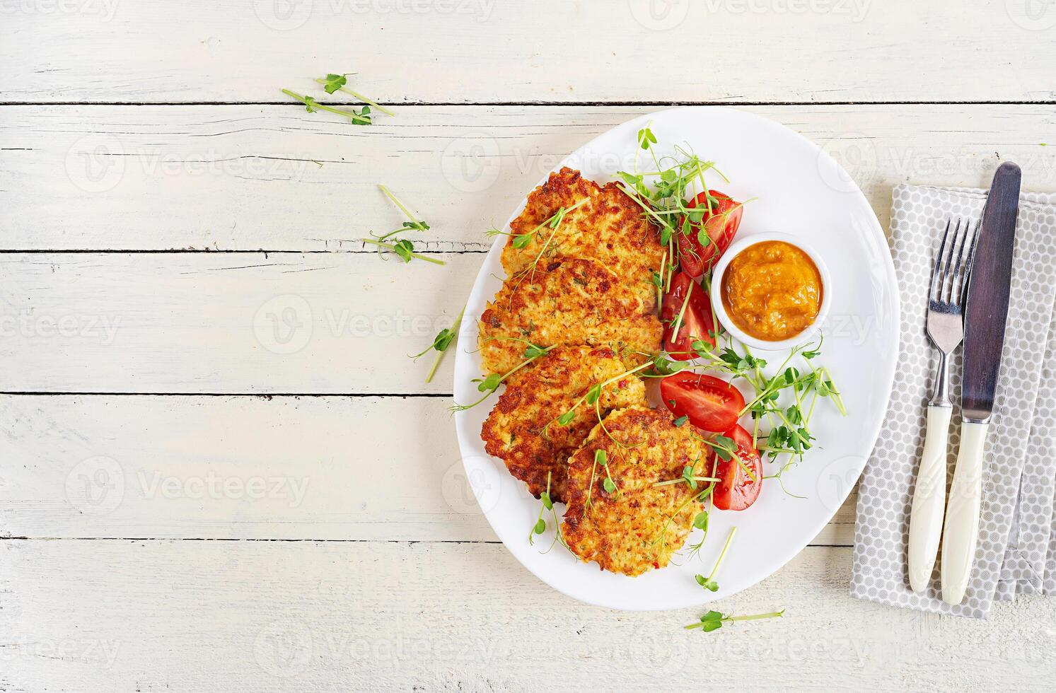 Potato fritters or pancakes served with sauce. European cuisine. Kosher eating. Vegan food. Top view, flat lay photo