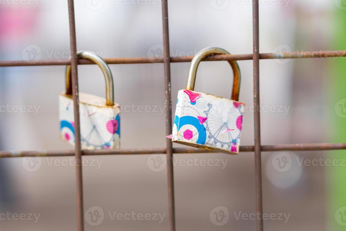 A close up of love padlocks attached to a railing photo