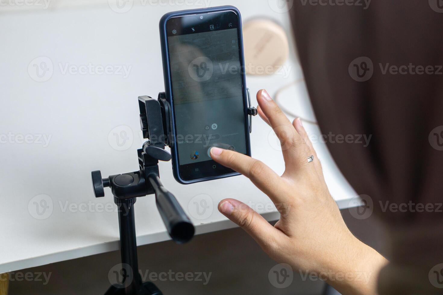 Woman with hijab preparing the recording mobile phone to make a and produce content photo