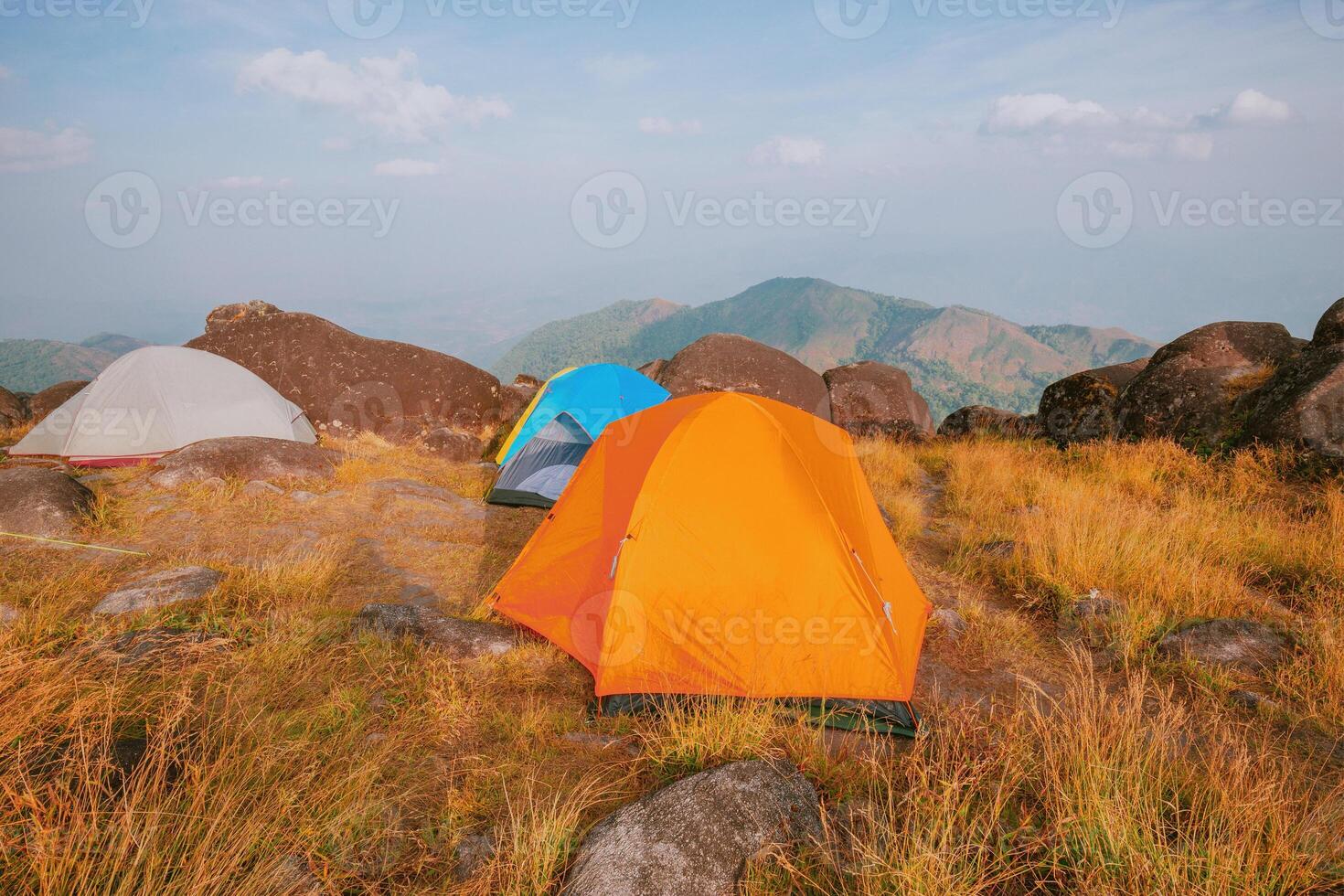 Set up a tent on the hill Full of grasslands photo