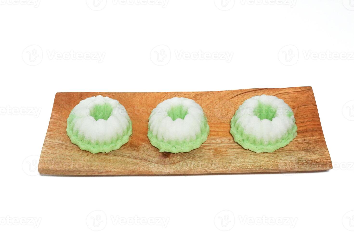 Green putu ayu is an Indonesian local cake made from rice flour and coconut milk with glaze of coconut photo