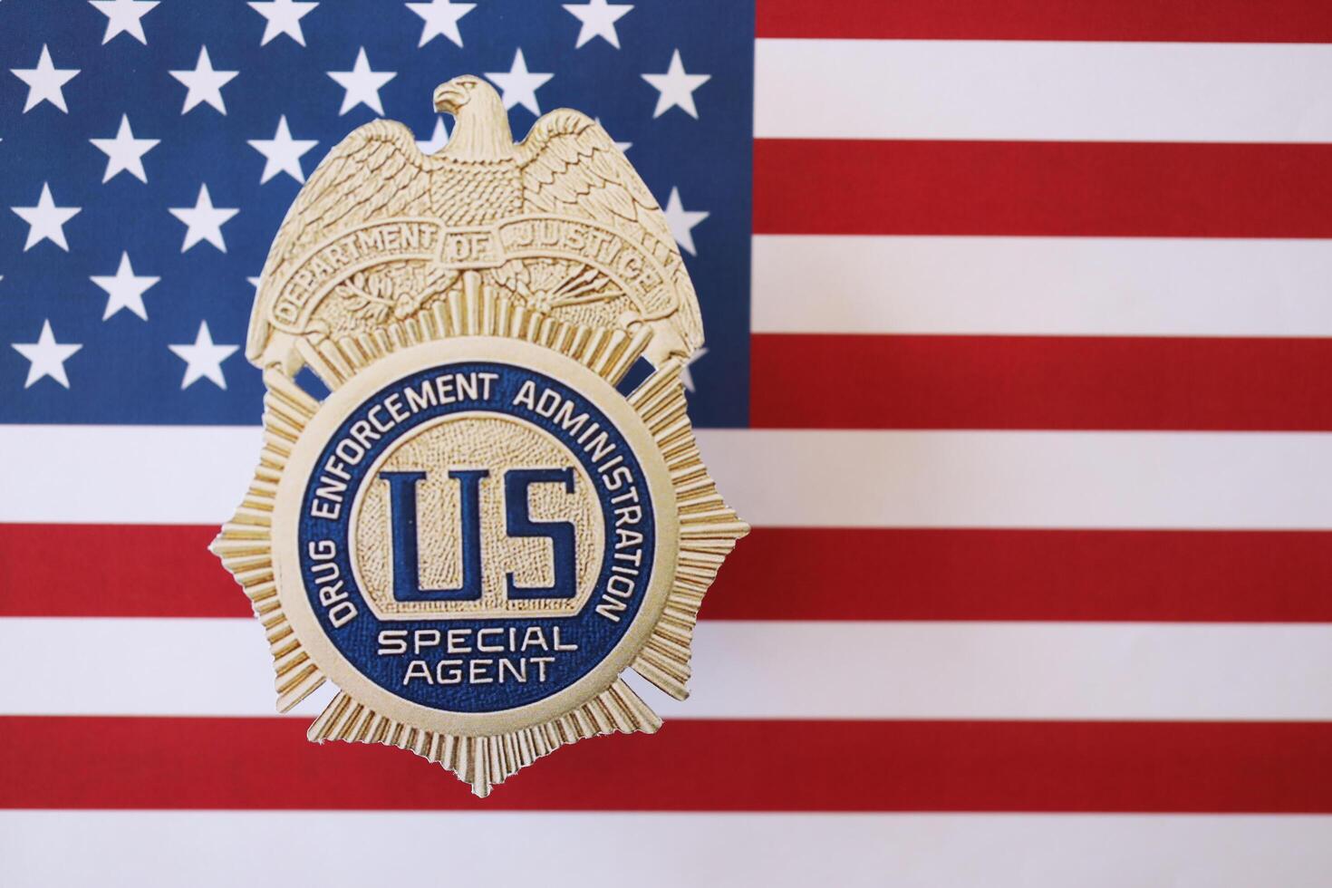 KYIV, UKRAINE - MARCH 9, 2024 US DEA Special Agent badge on United States of America flag photo