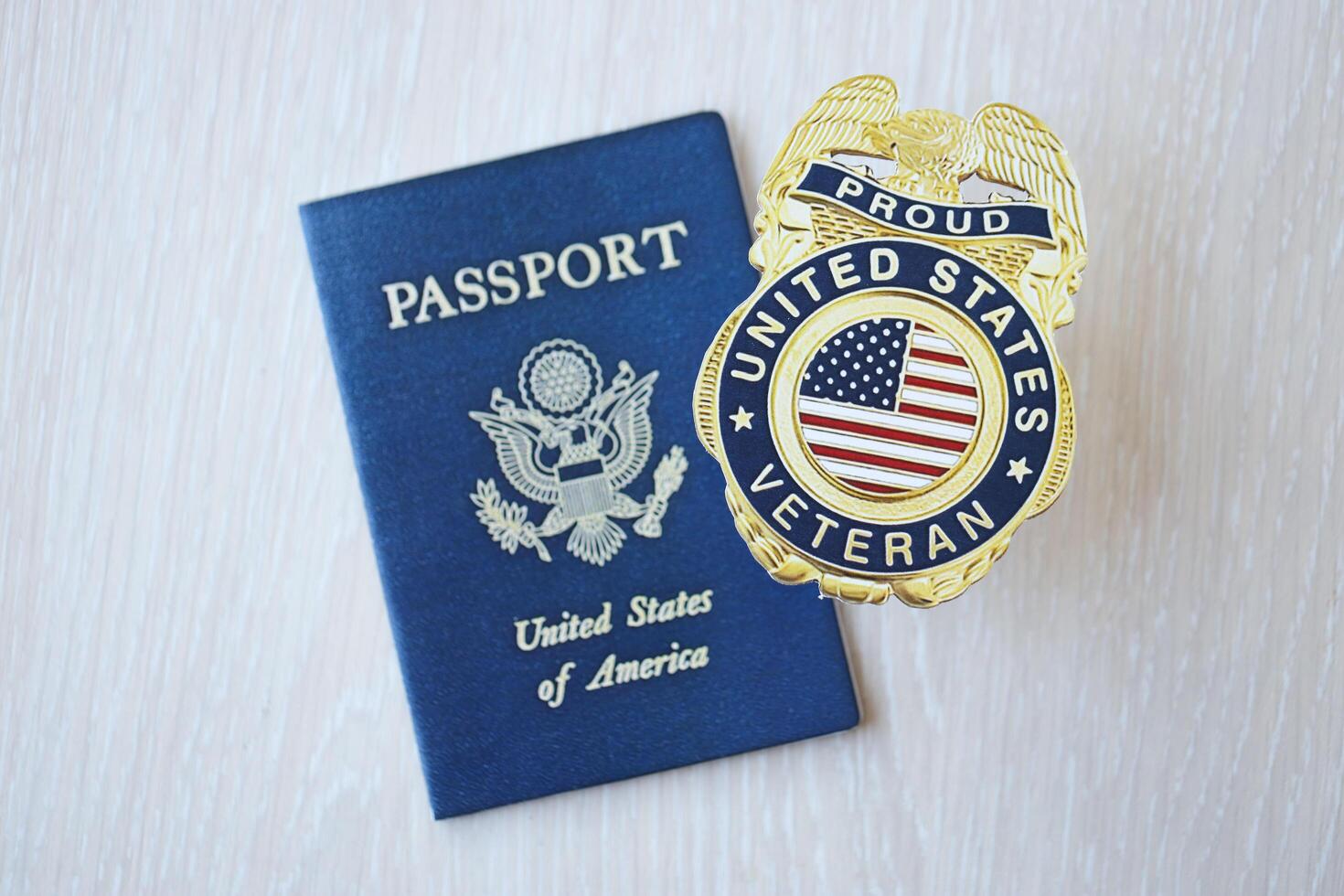 KYIV, UKRAINE - MARCH 9, 2024 US Proud Veteran badge and United States passport on wooden table photo