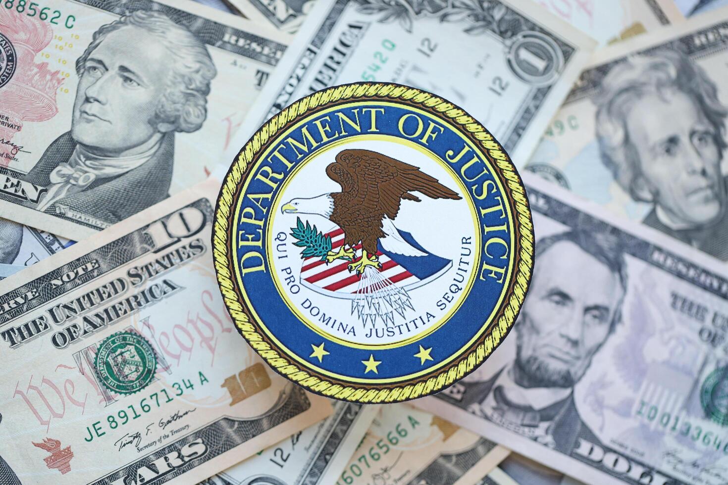 KYIV, UKRAINE - MARCH 9, 2024 US Department of Justice seal on many US dollar bills photo
