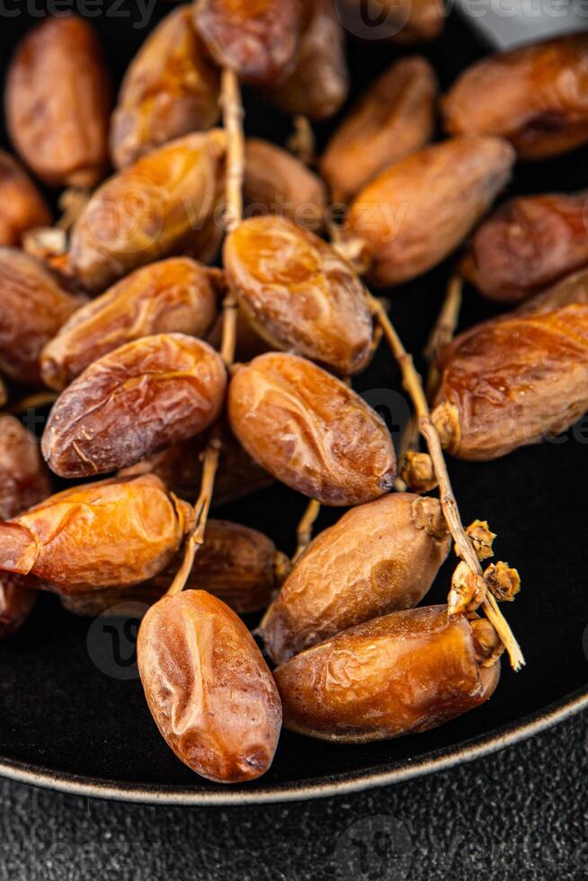 date branch dried sweet fruit fresh meal food snack on the table copy space food background rustic photo