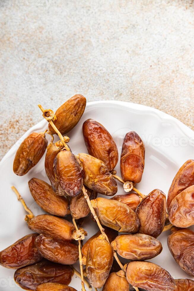 date branch dried sweet fruit fresh meal food snack on the table copy space food background rustic photo