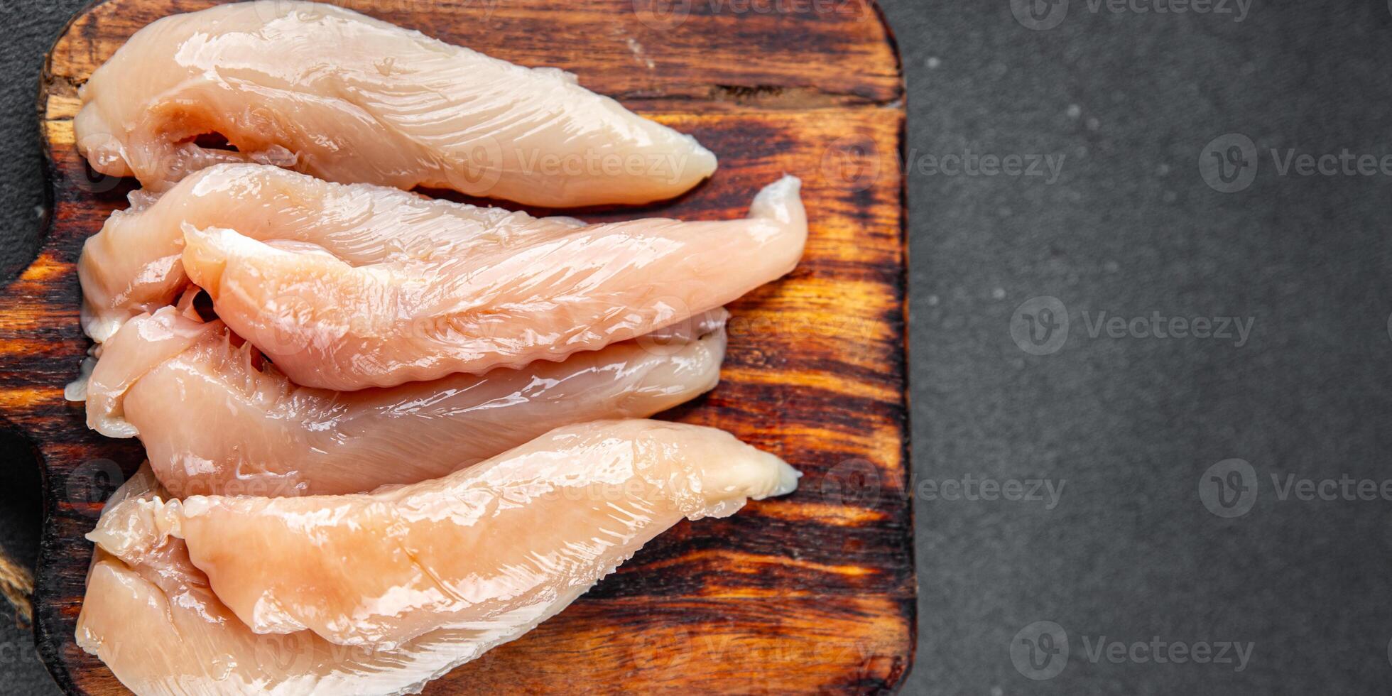 raw chicken meat aiguillettes fresh cooking appetizer meal food snack on the table copy space food background rustic top view keto or paleo diet photo