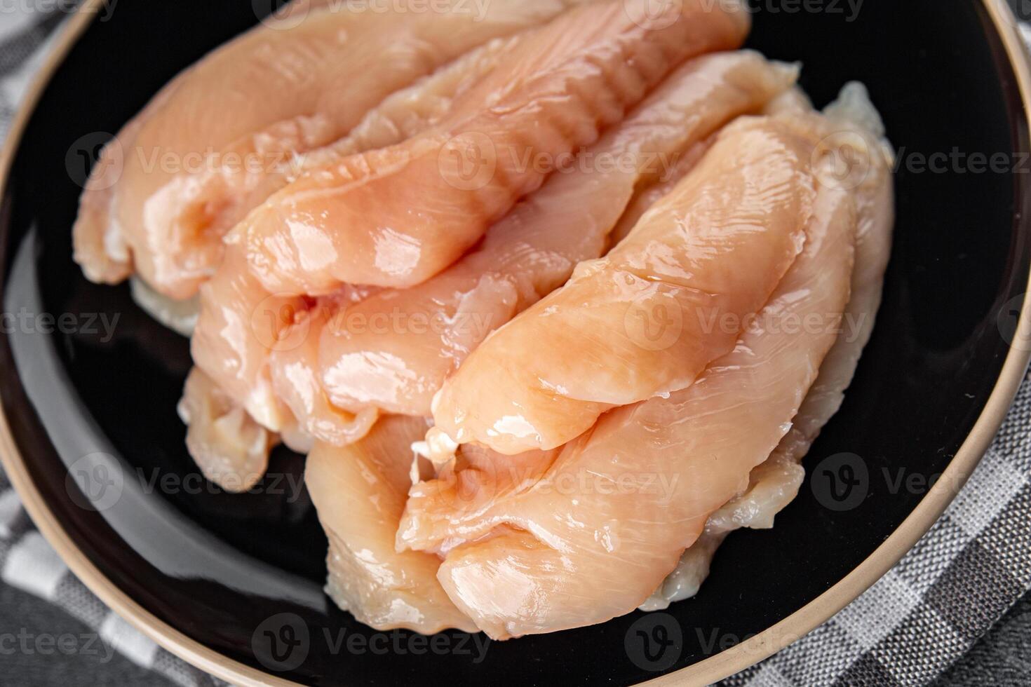raw chicken meat aiguillettes fresh cooking appetizer meal food snack on the table copy space food background rustic top view keto or paleo diet photo