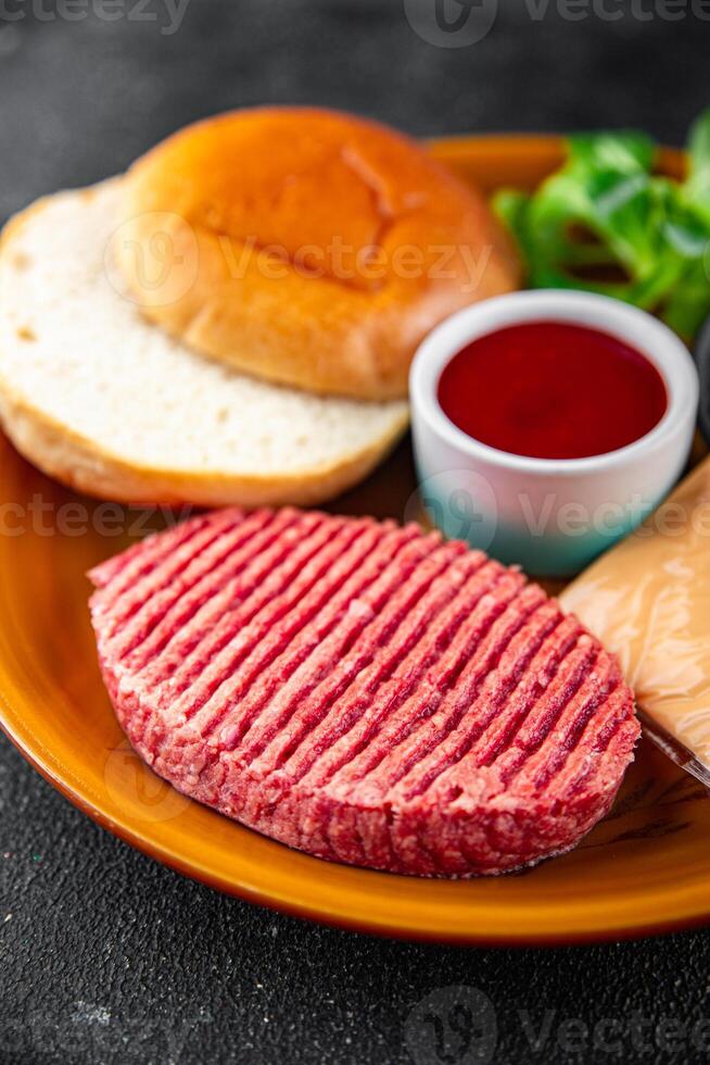 raw burger set cutlet, bun, cheese, tomato sauce, greens fresh cooking meal food snack on the table copy space food background photo