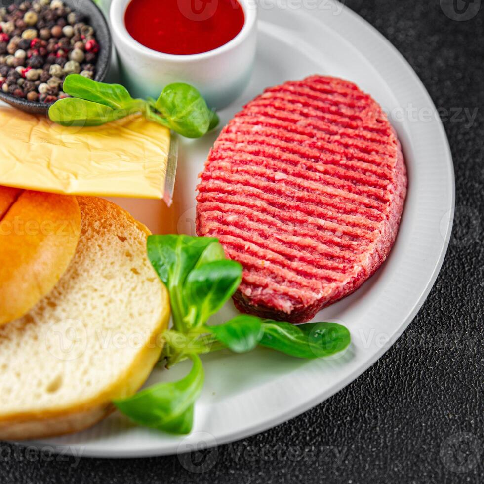 raw burger set cutlet, bun, cheese, tomato sauce, greens fresh cooking meal food snack on the table copy space food background photo