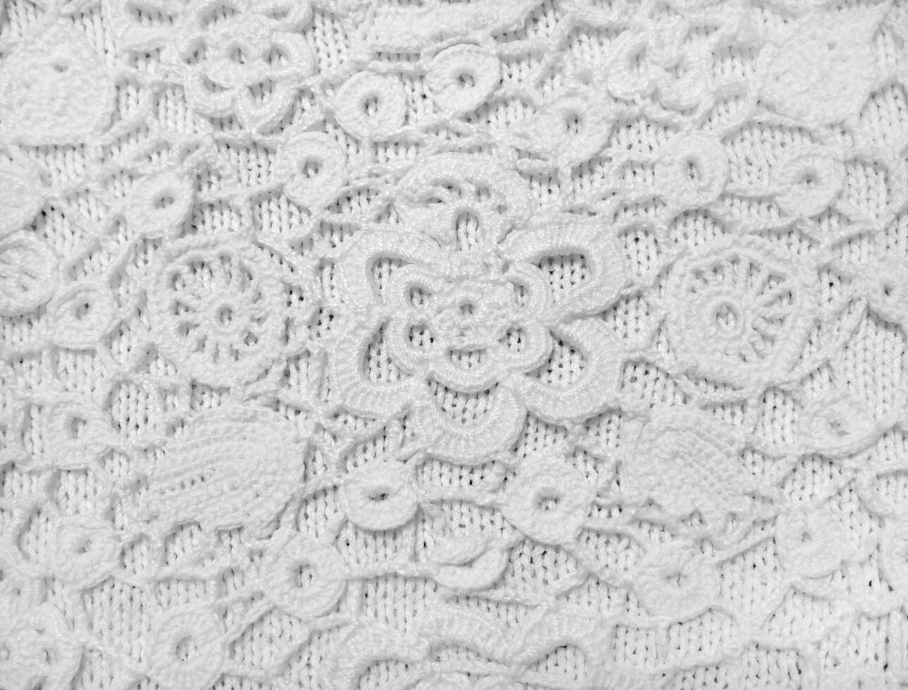 Crocheting from threads. Handmade Irish lace. Knitwear close-up. Selected sharpness photo