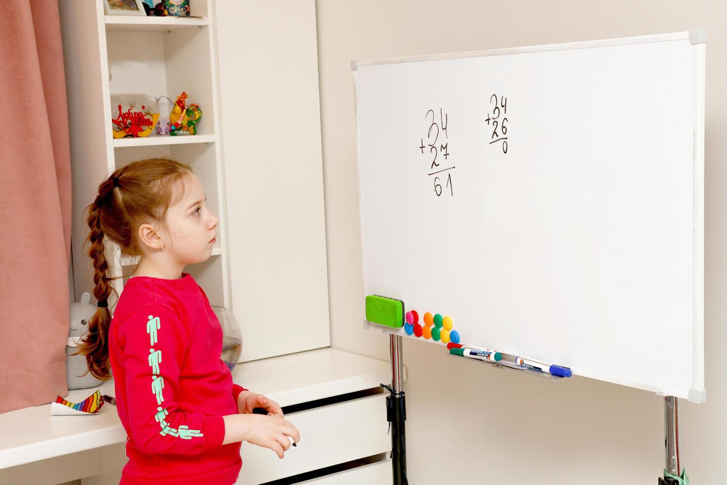 back to school, girl solves house example on blackboard photo