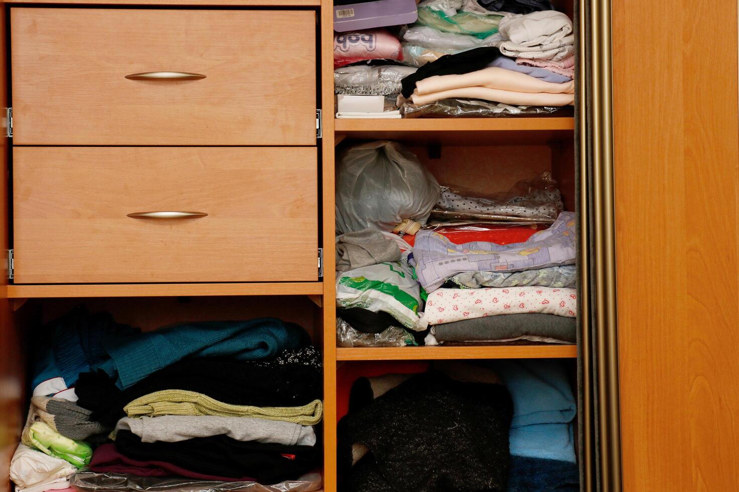 wardrobe with open door filled with clothes photo