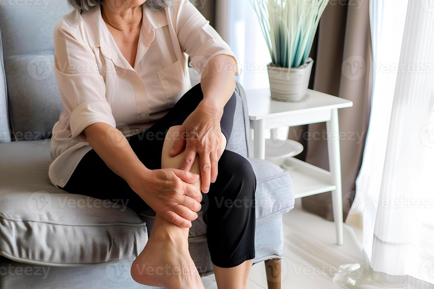Elder woman feeling leg pain. Concept of leg pain. photo
