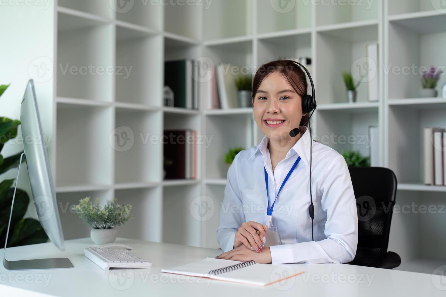 Call center woman asian in office for customer service, technical support and advice, contact and communication with employee operator in help desk agency photo