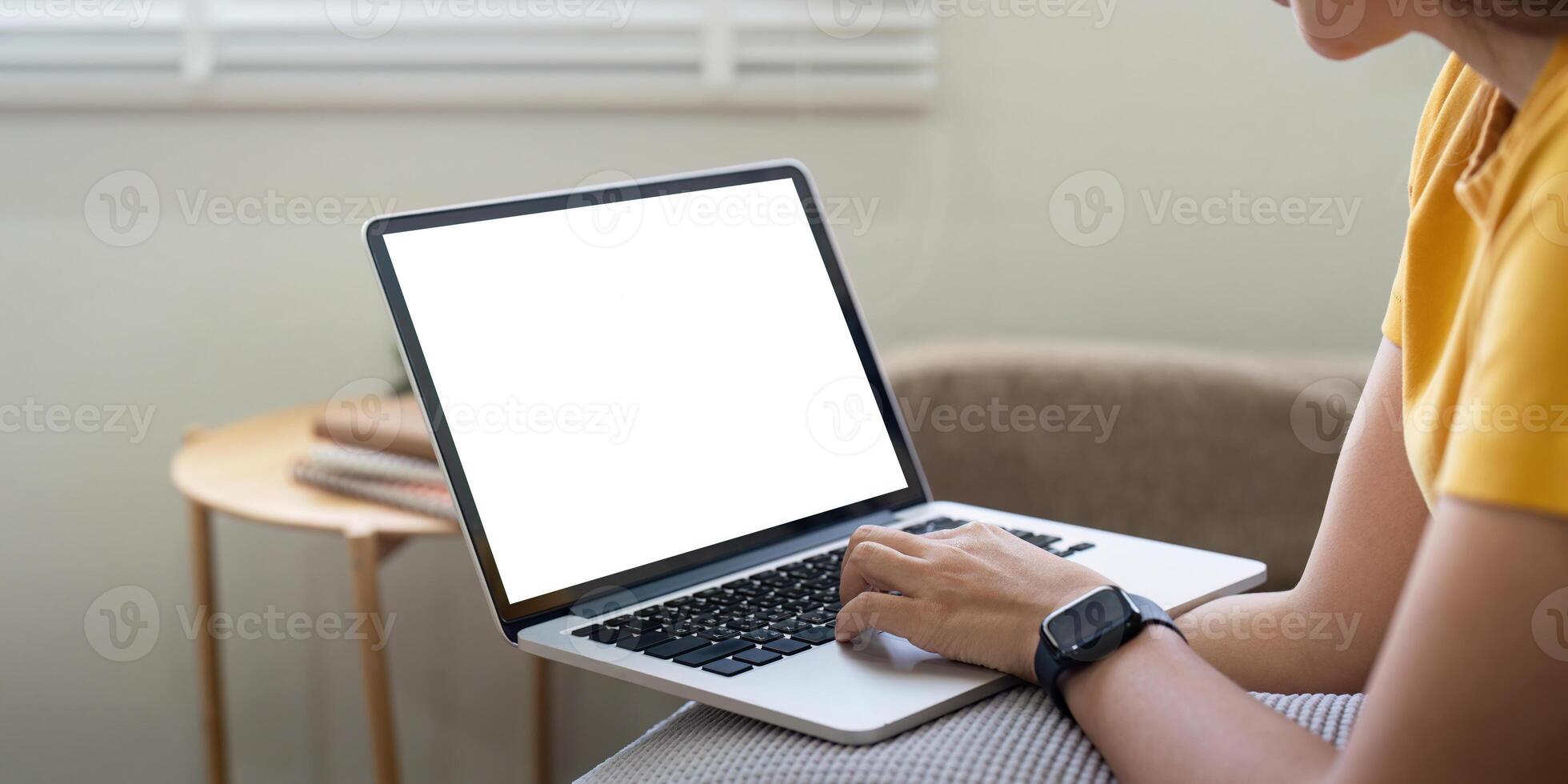 Young female with laptop at home on white blank screen for montage mockup display device in concept of lifestyle work at home with digital technology photo