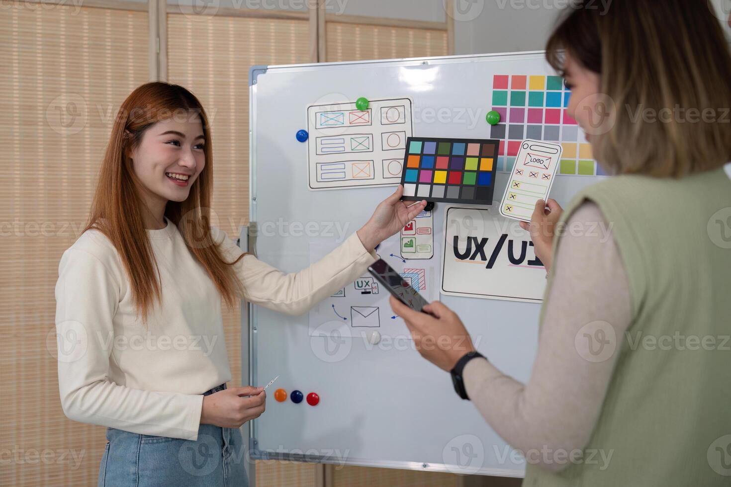 ux developer and ui designer presenting mobile app interface design on whiteboard in meeting at office. Creative digital development mobile app agency. digital transformation photo