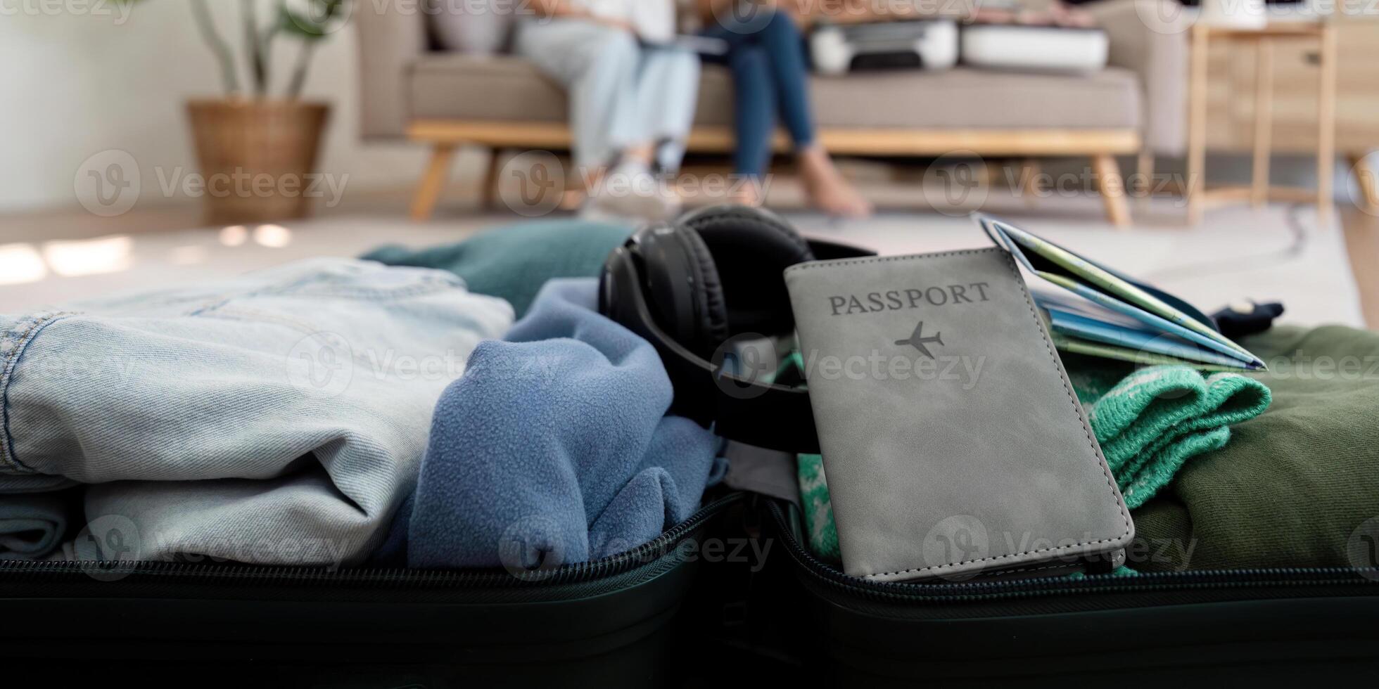 Friends and travel. Two asian young woman friends packing a travel bag before going on holidays photo