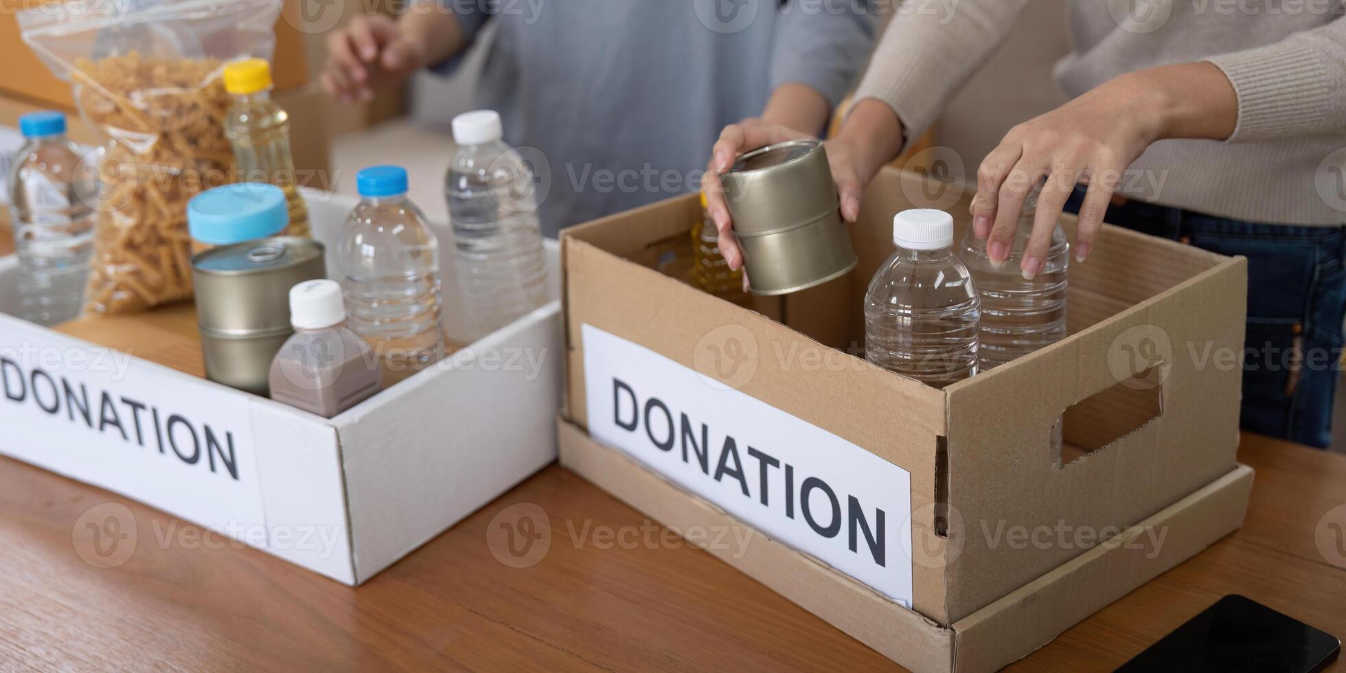 Volunteer preparing free foodstuff rations for poor people. Charity two woman of the community work together. concept of giving and humanitarian aid photo