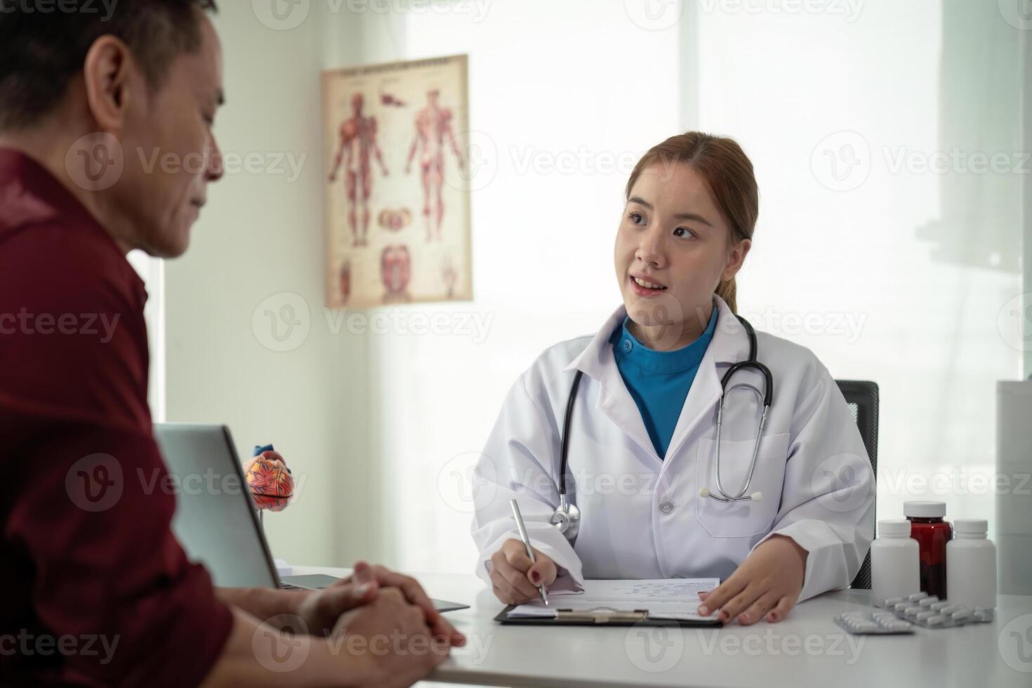 Doctor consulting male elderly patient filling medical form. Professional physician writing information in clipboard checking examining elderly man during appointment visit in clinic photo