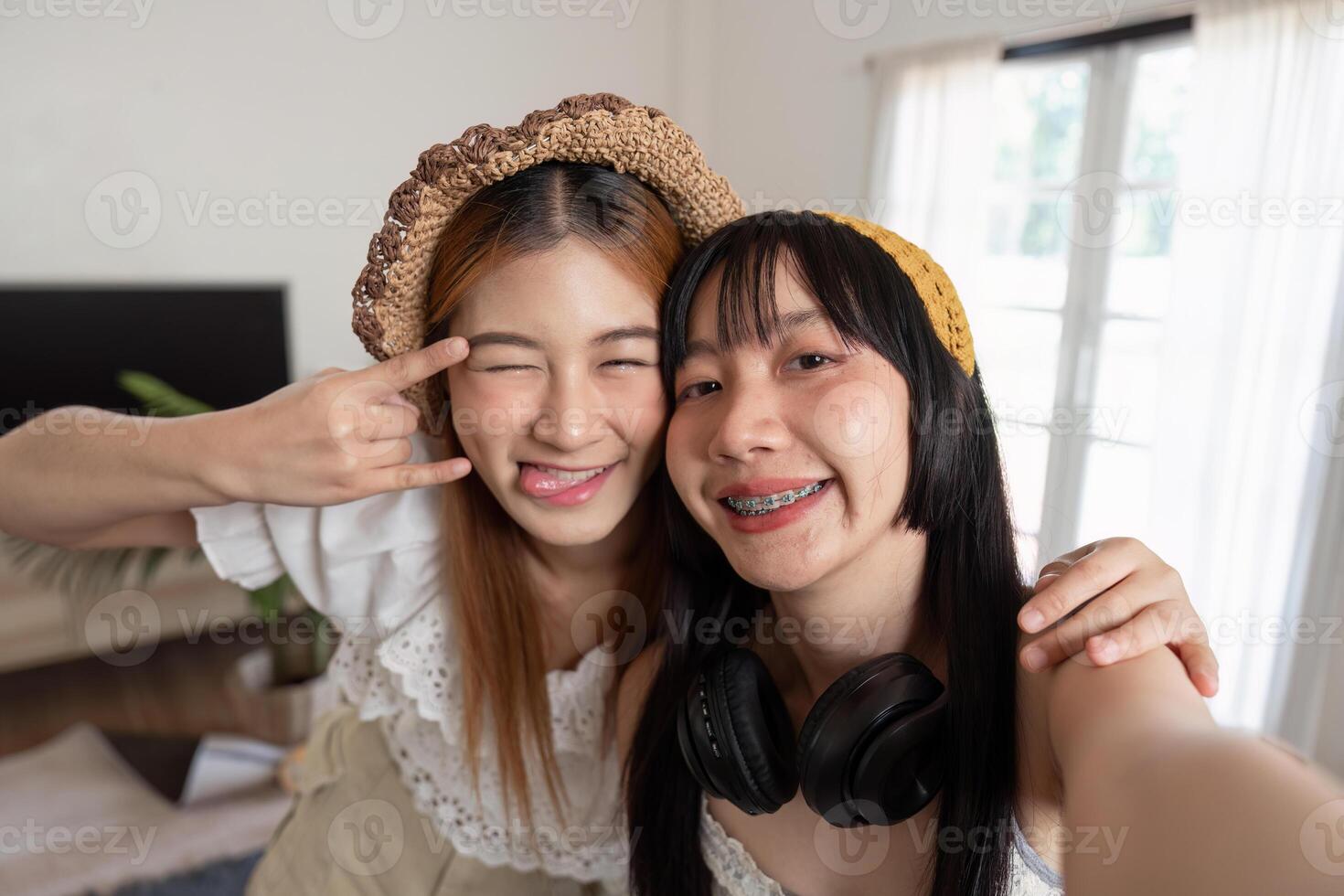 Two Asian woman traveler smile take a photo selfie together. Summer vacation travel concept