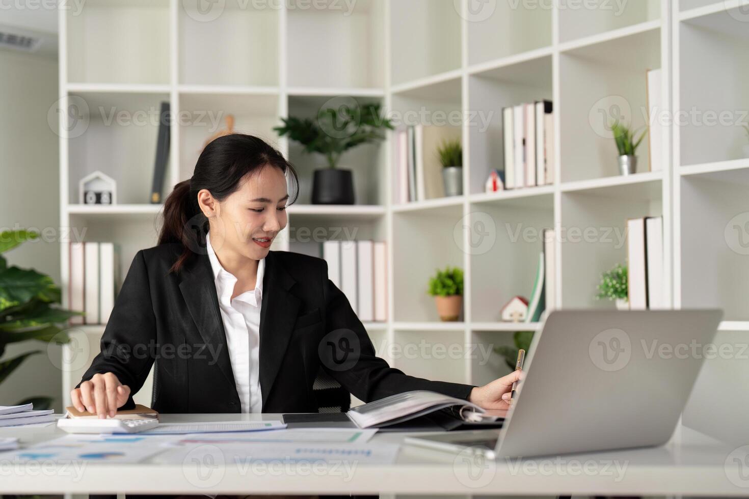 Asian woman accounting sit at their desks and calculate financial graph showing results about their investment, planning successful business growth process photo