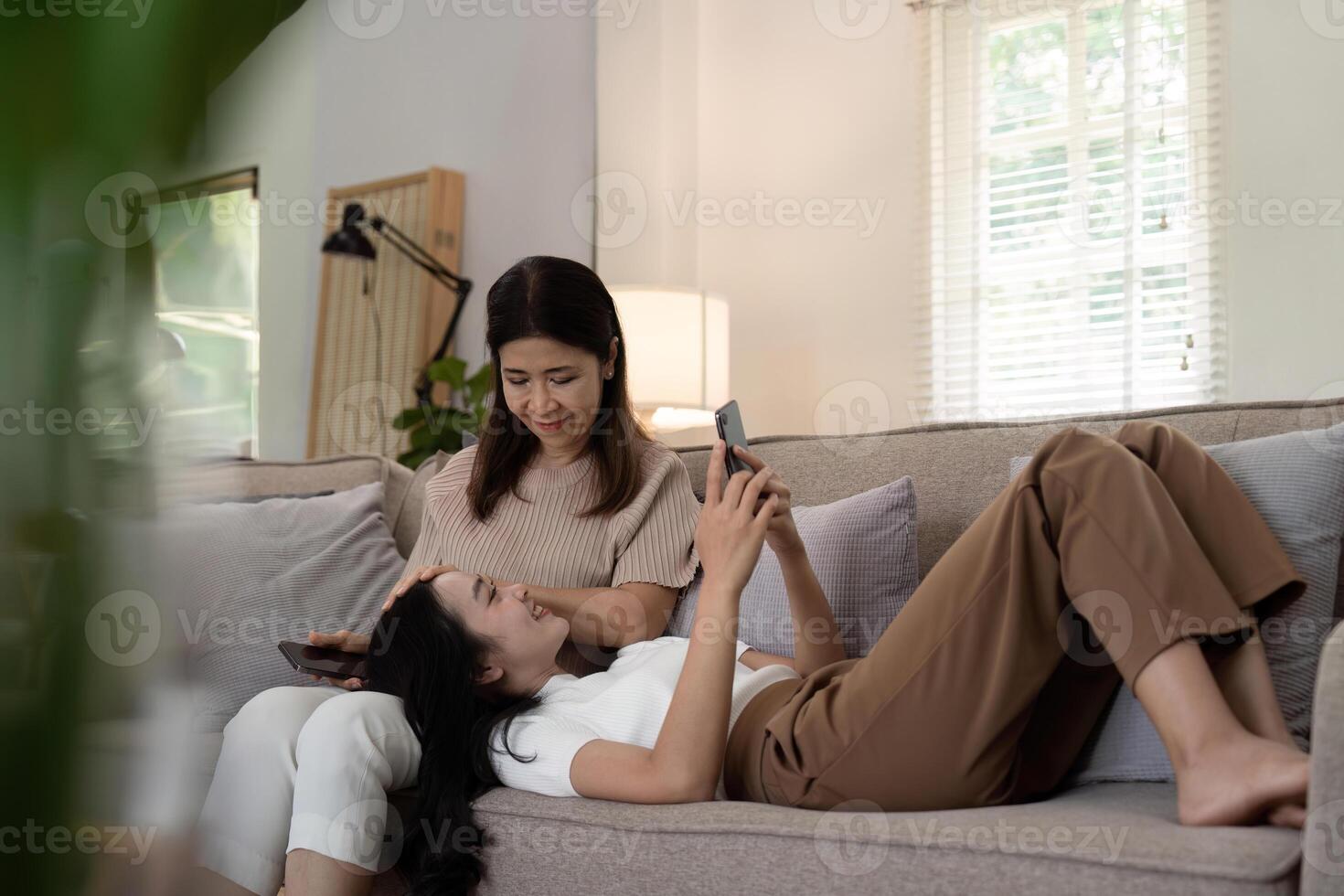 Adult daughter spending time with her senior mother at home photo