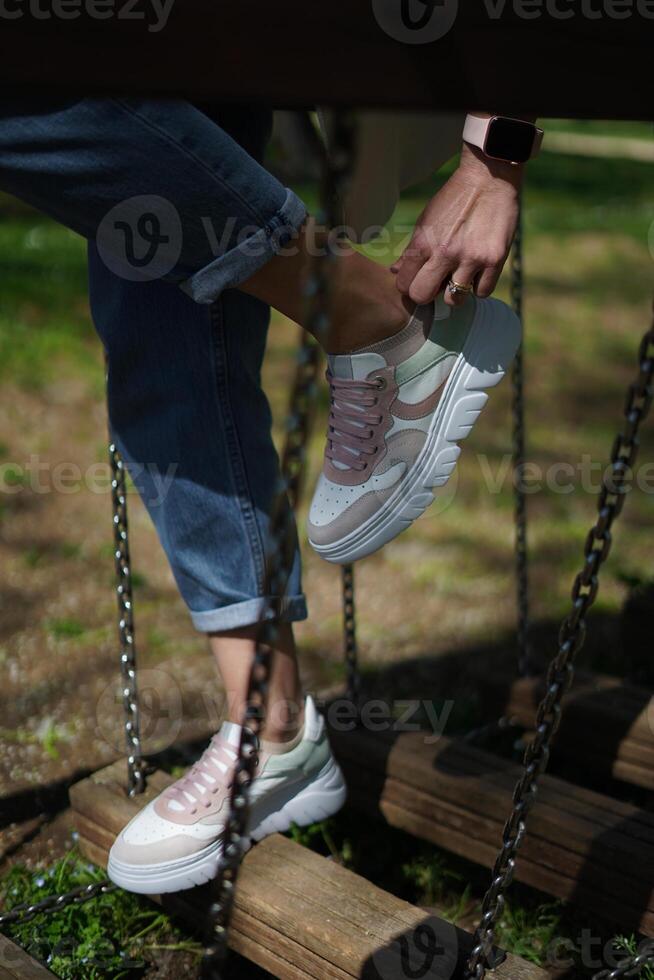 Girl adjusting her shoes photo