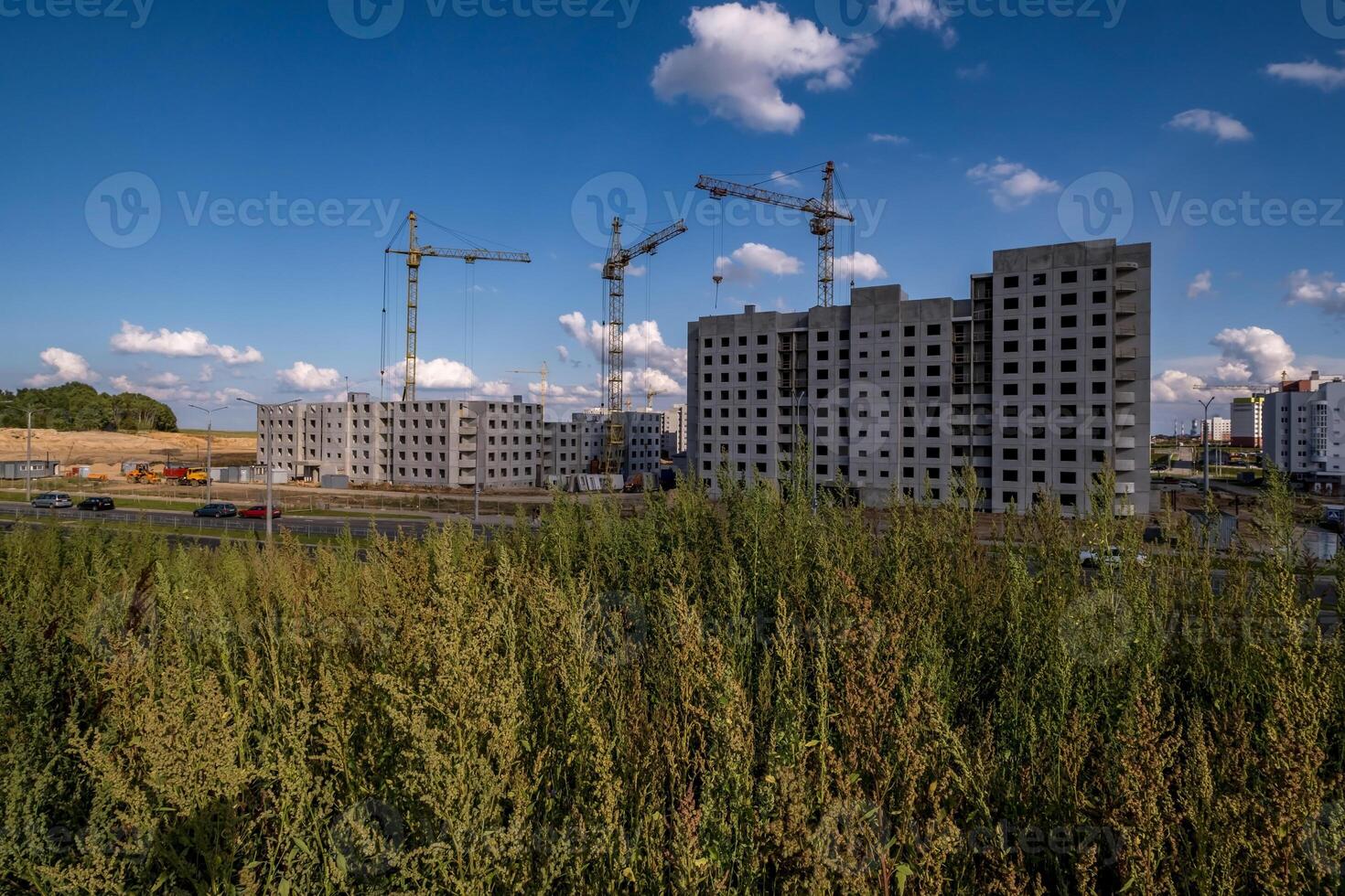 silhoette of tower cranes on construction site, providing housing for low-income citizens of third world countries photo
