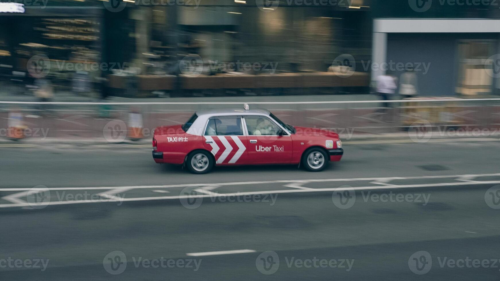 A fleet of Hong Kong taxis waiting at a taxi stand. Hong Kong taxis are easily recognizable by their red and white colors. photo