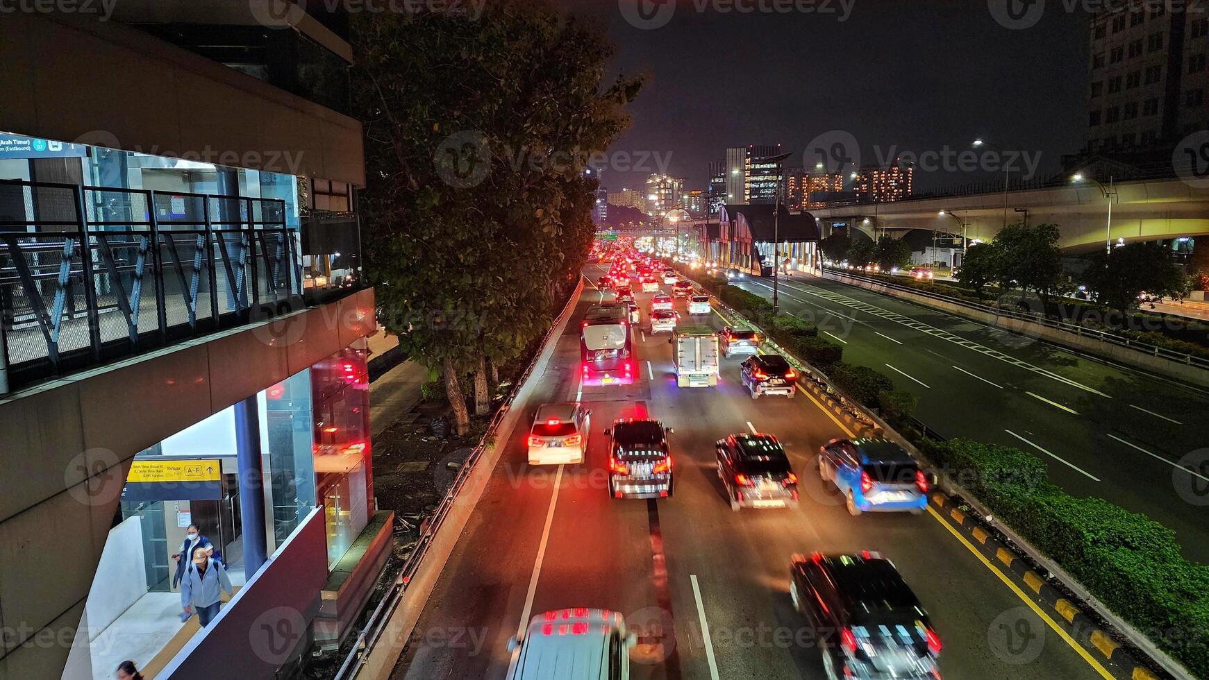 a busy street at night with cars and buses photo