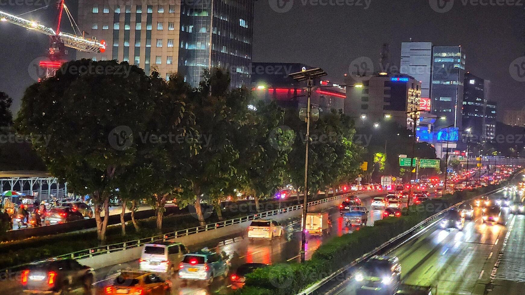 traffic is heavy on a busy city street at night photo