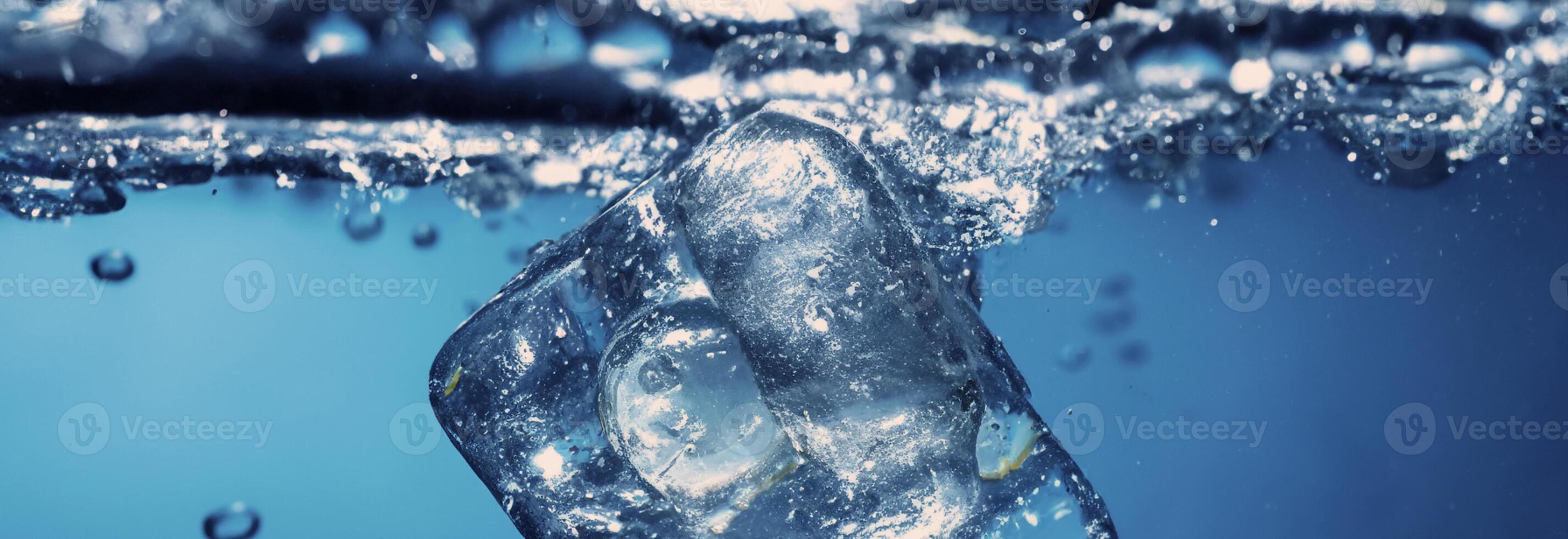Water splashing and ice cube. Ice splashing into a glass of water. Underwater pouring ice cubes falling into clear watering background. Refreshing chill drinking. Ices in a glass with blue background photo