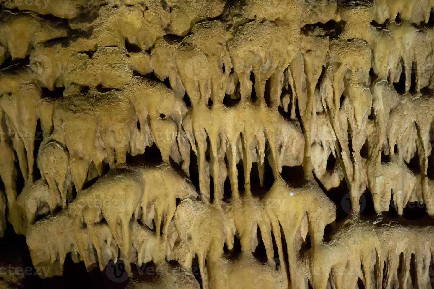 The cave is karst, amazing view of stalactites and stalagnites illuminated by bright light, a beautiful natural attraction in a tourist place. photo