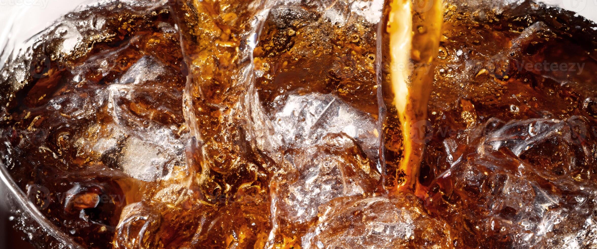 Cola soda and ice splashing fizzing or floating up to top of surface photo