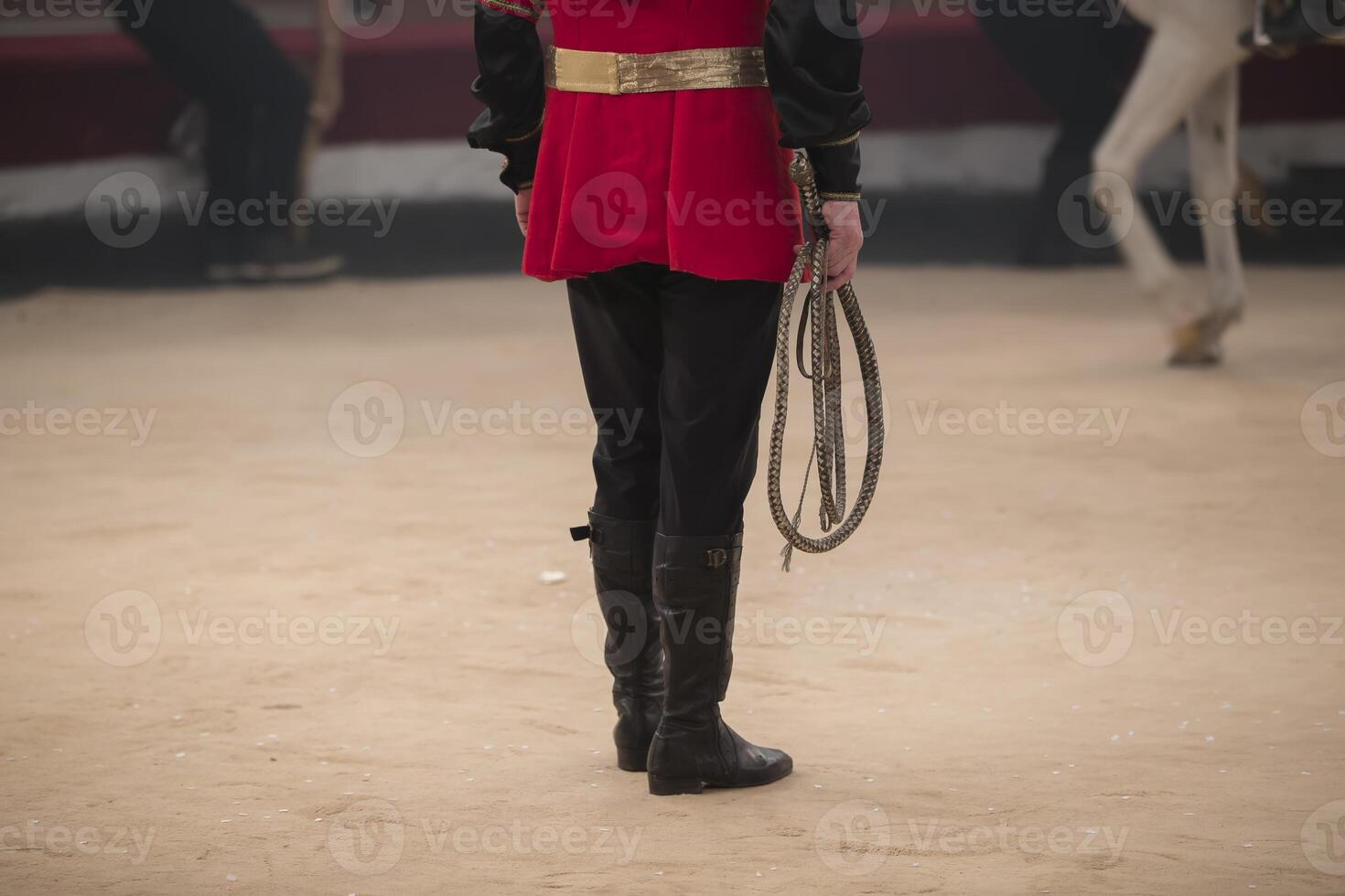 Circus trainer legs with a whip photo