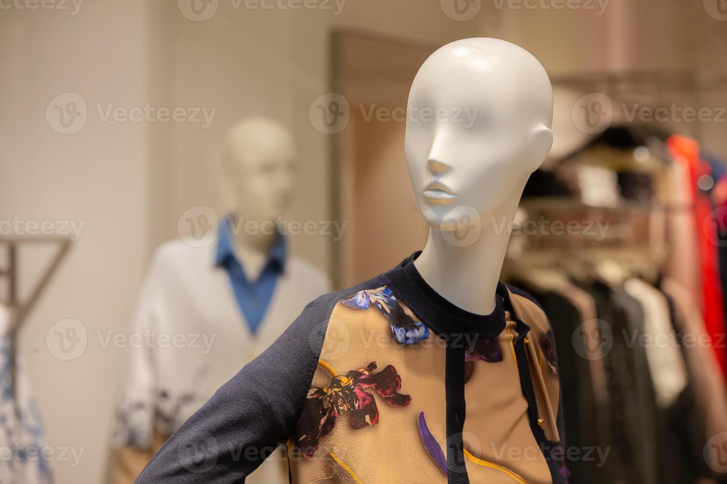 Female mannequin in floral clothing in a store window. photo