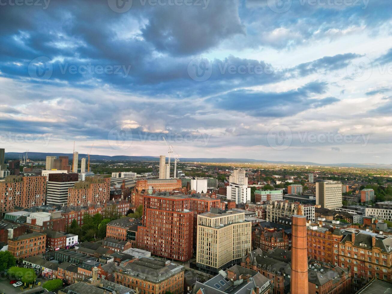 Aerial View of Greater Manchester City Centre and Tall Buildings During Golden Hour of Sunset. England UK. May 5th, 2024 photo