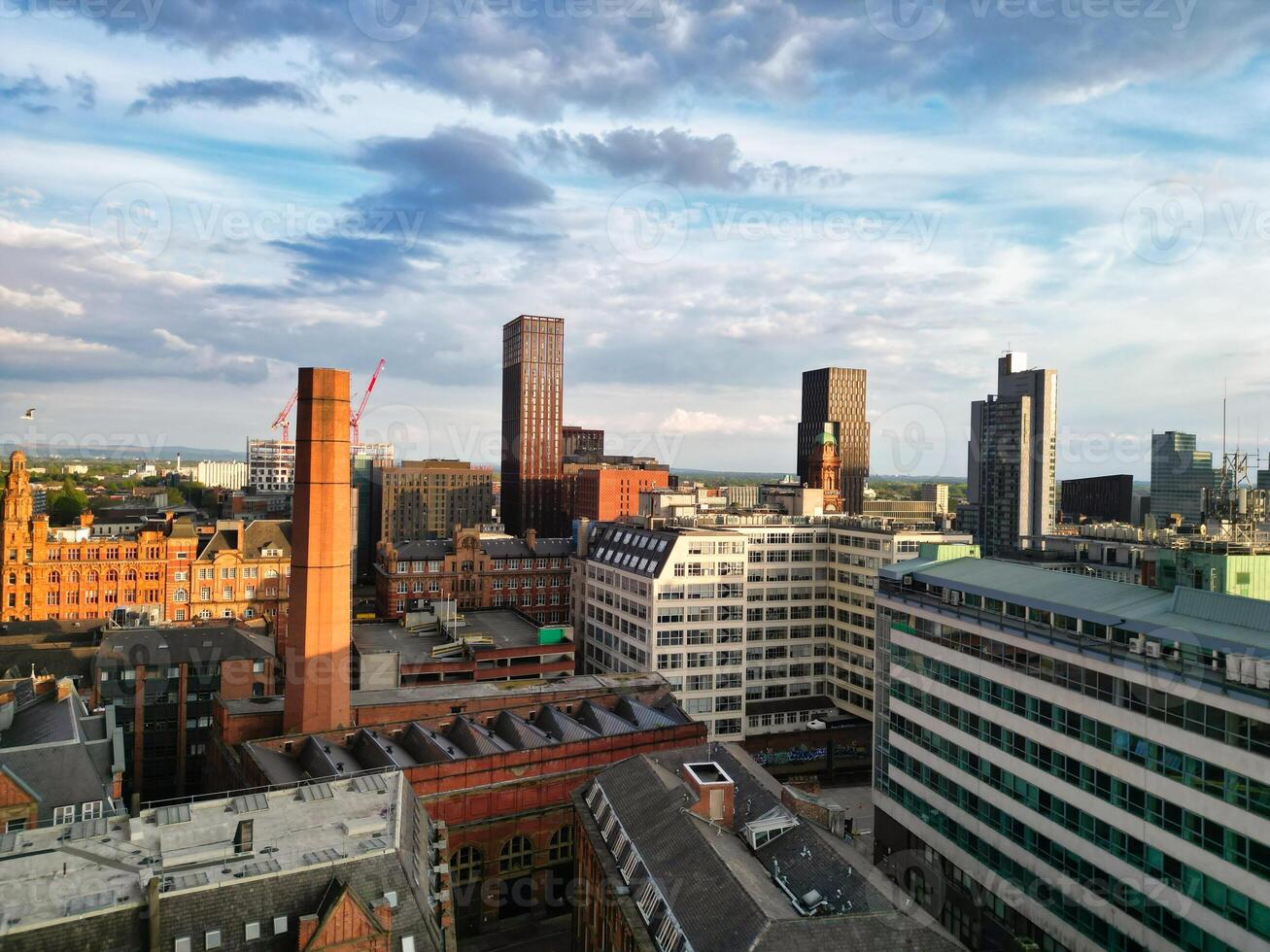 Aerial View of Greater Manchester City Centre and Tall Buildings During Golden Hour of Sunset. England UK. May 5th, 2024 photo