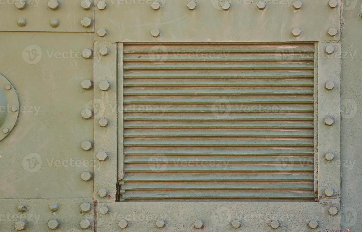 The texture of the wall of the tank, made of metal and reinforced with a multitude of bolts and rivets. Images of the covering of a combat vehicle from the Second World War photo