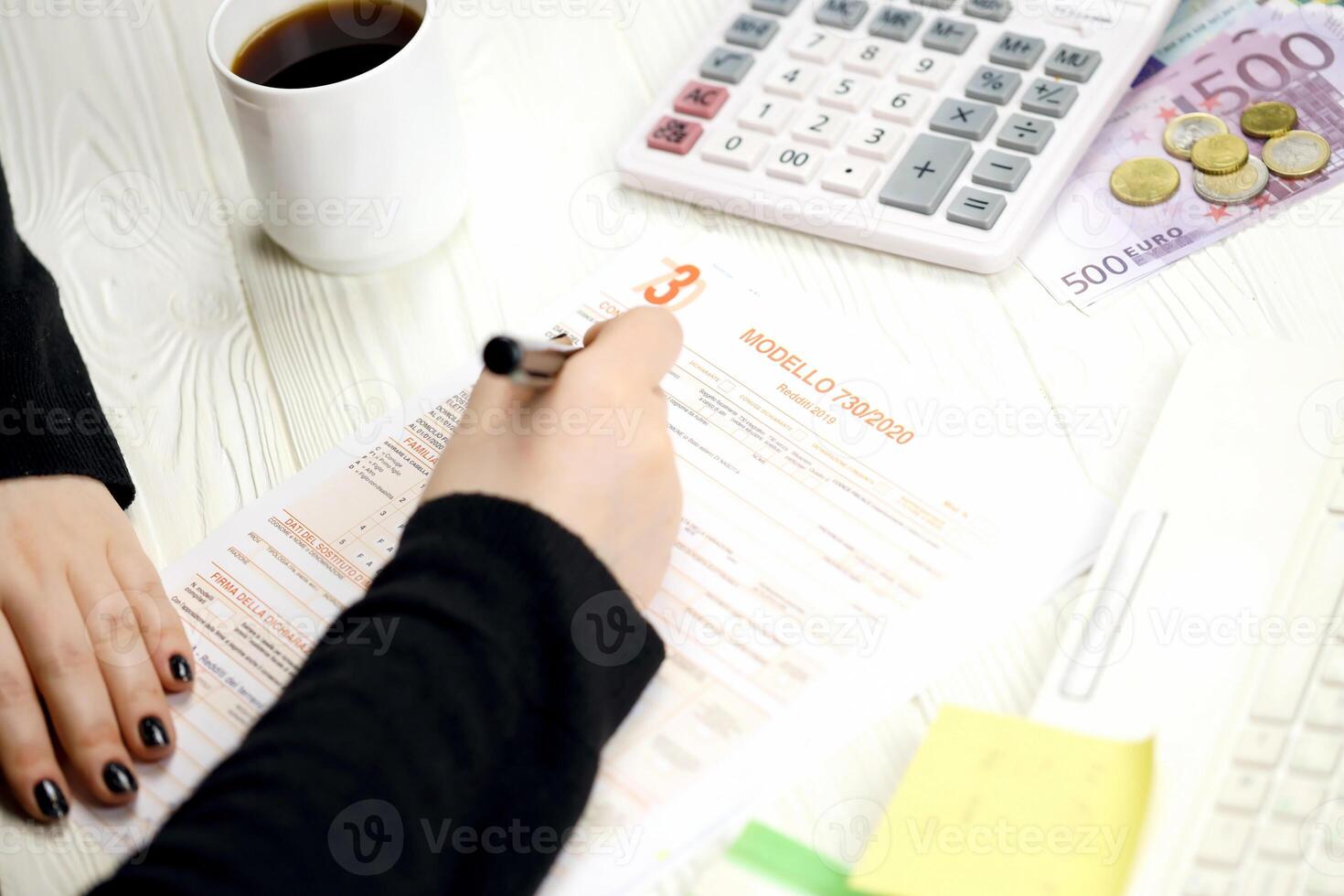 Accountant fill italian tax form Modello 730 individual income tax return in end of tax period. Taxation and paperwork routine photo