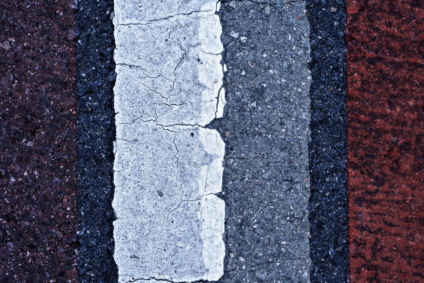 Old white traffic lines on the road. photo