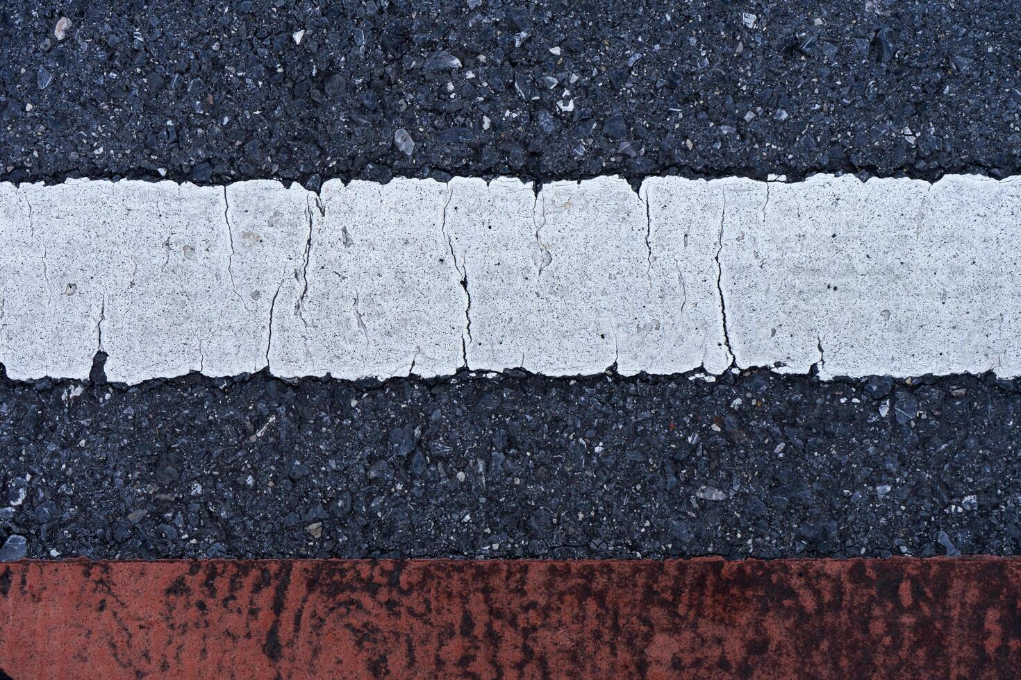 Old white traffic lines on the road. photo