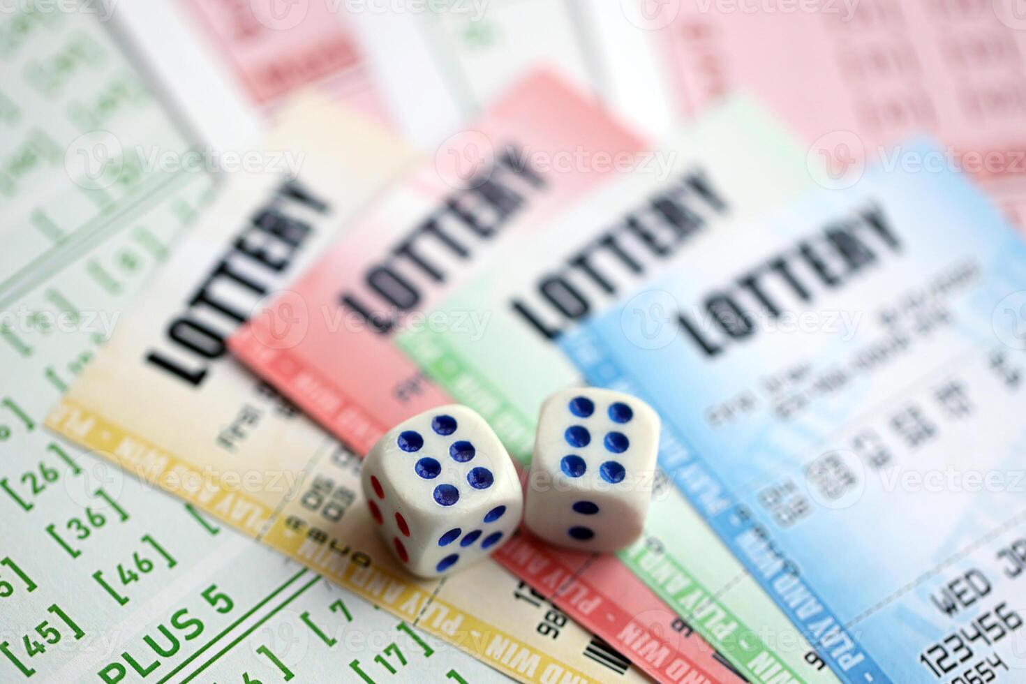 Lottery tickets of different colors and dice on blank bills with numbers for playing lottery photo